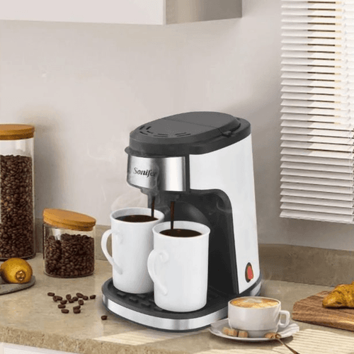 Machine à café et thé en céramique avec double tasse, idéale pour savourer café et thé en duo.